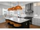 Bright kitchen with large island, stainless steel appliances, white cabinets, and eye-catching pendant lighting at 403 E Davis Blvd, Tampa, FL 33606