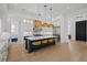 Kitchen features a large island with seating, pendant lighting, stainless steel appliances, and hardwood floors at 403 E Davis Blvd, Tampa, FL 33606