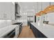 Modern kitchen with stainless steel appliances, large island, hardwood floors and stylish pendant lighting at 403 E Davis Blvd, Tampa, FL 33606