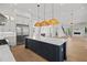 Spacious kitchen featuring an island with barstool seating, stainless appliances, and hardwood flooring at 403 E Davis Blvd, Tampa, FL 33606