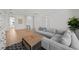 Spacious living area with a comfortable gray sofa, modern coffee table, and natural light from nearby windows at 403 E Davis Blvd, Tampa, FL 33606
