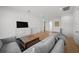 Bright, open-concept living space with modern decor, including a gray sofa, hardwood floors, and ample natural light at 403 E Davis Blvd, Tampa, FL 33606