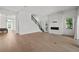 Open-concept living room with fireplace, staircase, and hardwood floors at 403 E Davis Blvd, Tampa, FL 33606