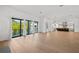Open-concept living room with hardwood floors, and sliding glass doors to the outside at 403 E Davis Blvd, Tampa, FL 33606