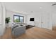 Bright living room with gray sofa, white walls, hardwood floors, and a large window offering a scenic view at 403 E Davis Blvd, Tampa, FL 33606
