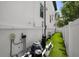 Outdoor shot of pool equipment, green grass, white privacy fence, and the exterior of the home at 403 E Davis Blvd, Tampa, FL 33606