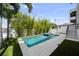 Backyard pool with jacuzzi, decorative landscape, and modern patio, perfect for relaxing and entertaining at 403 E Davis Blvd, Tampa, FL 33606