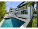 The backyard features a pool, jacuzzi, and modern patio space leading up to the home's back entry at 403 E Davis Blvd, Tampa, FL 33606