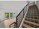 Modern staircase design with black metal railings and patterned tile risers, leading to an open living area at 403 E Davis Blvd, Tampa, FL 33606