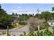 A charming street view with a glimpse of the tranquil water in the distance, surrounded by lush greenery at 403 E Davis Blvd, Tampa, FL 33606