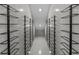 Modern wine room featuring black metal racks against light gray tile walls and floor, illuminated by recessed lighting at 403 E Davis Blvd, Tampa, FL 33606