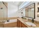 Bathroom features a soaking tub, dual sinks, granite countertops, and tiled shower at 407 S Fremont Ave # B, Tampa, FL 33606