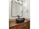 Modern bathroom with a dark wood vanity, a unique vessel sink, and stylish lighting at 407 S Fremont Ave # B, Tampa, FL 33606