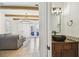 Bathroom featuring a dark wood vanity and a unique vessel sink, with an open view to the living room at 407 S Fremont Ave # B, Tampa, FL 33606