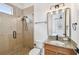 Elegant bathroom features a glass-enclosed shower, granite countertop and attractive light fixture at 407 S Fremont Ave # B, Tampa, FL 33606