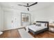 Bedroom with hardwood floors, ceiling fan, natural light, and stylish decor at 407 S Fremont Ave # B, Tampa, FL 33606