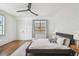 Bedroom with hardwood floors, ceiling fan, large window, and stylish decor at 407 S Fremont Ave # B, Tampa, FL 33606