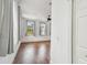 Bright bedroom with hardwood floors, neutral walls, ceiling fan, and windows with views of the lush landscaping at 407 S Fremont Ave # B, Tampa, FL 33606