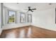 An empty bedroom with 3 windows, light hardwood floors, a ceiling fan and bright neutral paint at 407 S Fremont Ave # B, Tampa, FL 33606