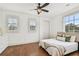 Bright bedroom showcasing hardwood floors, natural light, and neutral decor for a peaceful ambiance at 407 S Fremont Ave # B, Tampa, FL 33606