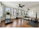 Bright exercise room featuring hardwood floors, large mirror, ceiling fan, and abundant natural light at 407 S Fremont Ave # B, Tampa, FL 33606
