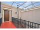 Exterior architecture showing a walkway with iron railings and overhead lattice, leading to a unit's front door at 407 S Fremont Ave # B, Tampa, FL 33606