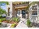 Charming home featuring a welcoming front porch, arched windows, and a beautifully landscaped walkway at 407 S Fremont Ave # B, Tampa, FL 33606