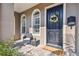 Charming front porch with seating, a 'welcome' mat, and decorative door wreath at 407 S Fremont Ave # B, Tampa, FL 33606
