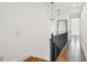 Hallway features modern light fixtures, hardwood floors, iron railing, and light wall paint at 407 S Fremont Ave # B, Tampa, FL 33606