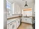 Modern kitchen with white cabinets, granite countertops, stainless steel appliances, and a large window at 407 S Fremont Ave # B, Tampa, FL 33606