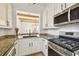 Modern kitchen with white cabinets, stainless steel appliances, and an open view to the living room at 407 S Fremont Ave # B, Tampa, FL 33606