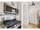 Close up of modern kitchen featuring stainless steel gas range and overhead microwave oven at 407 S Fremont Ave # B, Tampa, FL 33606