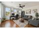 Comfortable living room with hardwood floors, ceiling fan, neutral paint and three windows for natural light at 407 S Fremont Ave # B, Tampa, FL 33606