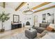 Comfortable living room showcasing a fireplace, decorative rug, exposed beams, and contemporary furnishings at 407 S Fremont Ave # B, Tampa, FL 33606