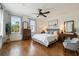 Bright bedroom featuring wood floors, a ceiling fan, neutral paint and two windows for natural light at 407 S Fremont Ave # B, Tampa, FL 33606