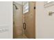 Modern shower with glass door, tiled walls, tiled floor and shower head at 407 S Fremont Ave # B, Tampa, FL 33606