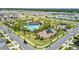 Aerial view of community pool, clubhouse and playground nestled among manicured grounds at 4917 Eagle Rock Dr, Wimauma, FL 33598