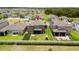 Aerial view of the backyard featuring a lush lawn, fence, screened-in patio, and a small playset at 4917 Eagle Rock Dr, Wimauma, FL 33598