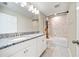 Bright bathroom featuring double vanity with granite counters and a tub with tiled walls at 4917 Eagle Rock Dr, Wimauma, FL 33598