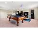Bonus room featuring an ornate pool table, stylish cabinets and a flat screen tv at 4917 Eagle Rock Dr, Wimauma, FL 33598