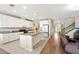 Well-lit kitchen featuring white cabinets, granite countertops, and a functional center island at 4917 Eagle Rock Dr, Wimauma, FL 33598