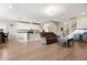 Spacious living area with an open-concept design, modern lighting, and access to the staircase at 4917 Eagle Rock Dr, Wimauma, FL 33598