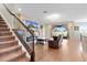 Cozy living room with staircase, wooden floors, and a sliding glass door at 4917 Eagle Rock Dr, Wimauma, FL 33598