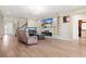 Inviting living area featuring a modern fireplace, an entertainment center, and elegant decor at 4917 Eagle Rock Dr, Wimauma, FL 33598