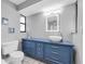 Modern bathroom with blue vanity, vessel sink, and white tiled floor at 502 Timber Bay E Cir, Oldsmar, FL 34677