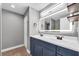 Modern bathroom with double sink vanity, illuminated mirror, and tiled flooring at 502 Timber Bay E Cir, Oldsmar, FL 34677