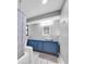 Bathroom features a blue vanity with a modern vessel sink, tiled floors, and a shower with a gray pattern curtain at 502 Timber Bay E Cir, Oldsmar, FL 34677