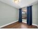 Cozy bedroom featuring a window with blue curtains and wood-look flooring at 502 Timber Bay E Cir, Oldsmar, FL 34677