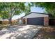 Charming single-story home featuring brick accents, mature trees, and an attached two-car garage at 502 Timber Bay E Cir, Oldsmar, FL 34677