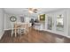 Open-concept kitchen with stainless appliances, white cabinetry, breakfast bar and eat-in dining area at 502 Timber Bay E Cir, Oldsmar, FL 34677